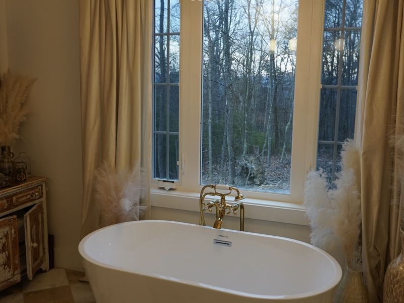 luxurious bathtub with window and chandelier va